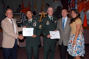 In August, Larry Bingaman (l), chapter treasurer; Vitoria Mello (r), chapter vice president for publicity; and Richard Besselman (2nd from r), chapter president; congratulate Staff Sgt. Brian Hong, USA (2nd from l), and Spc. Daniel Justice, USA, both from the 5th Signal Command (Theater). They received recognition at the Network Enterprise Technology Command awards ceremony.